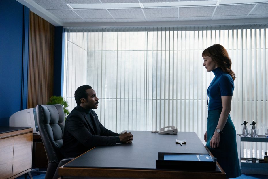 Severance character Helly R stands in front of severed floor manager Mr. Milchick's desk in an image taken from the show.